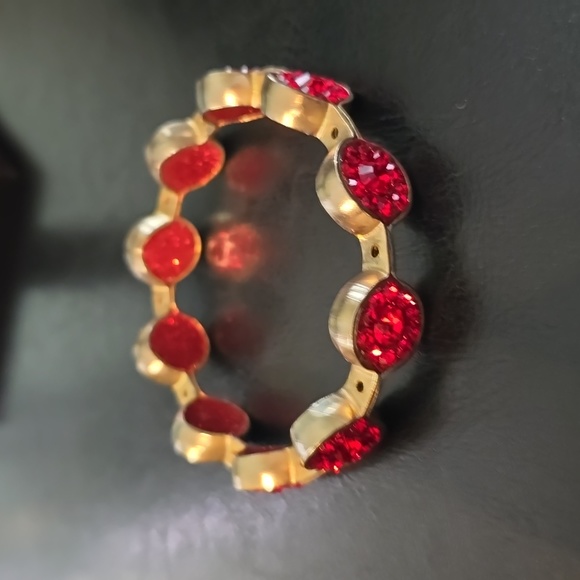 Gold tone bangle bracelet with red crystals. - Picture 2 of 2